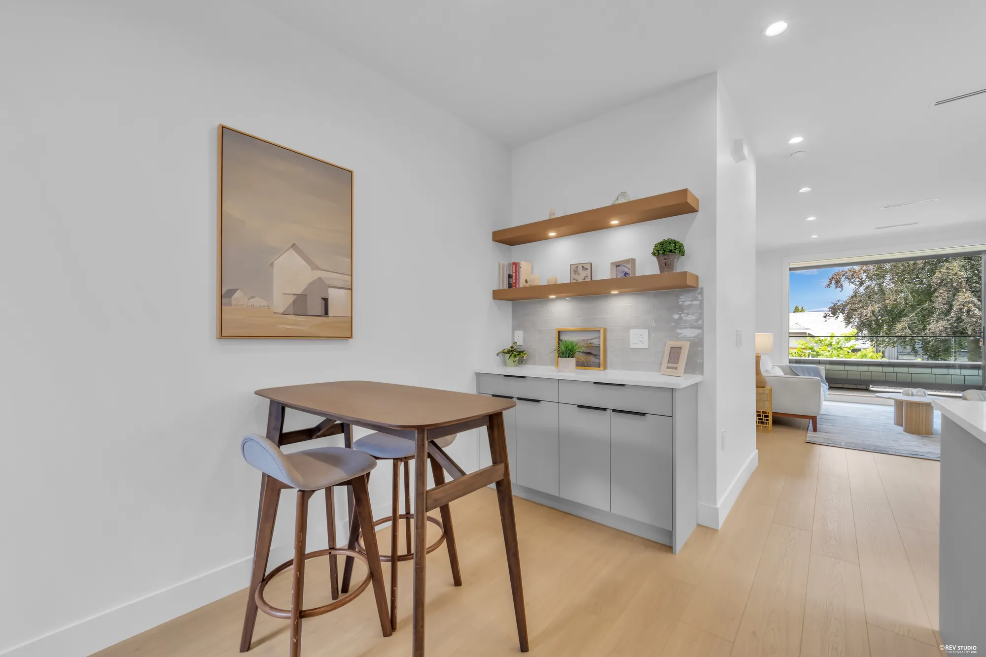 Breakfast bar with two stools under open timber shelves