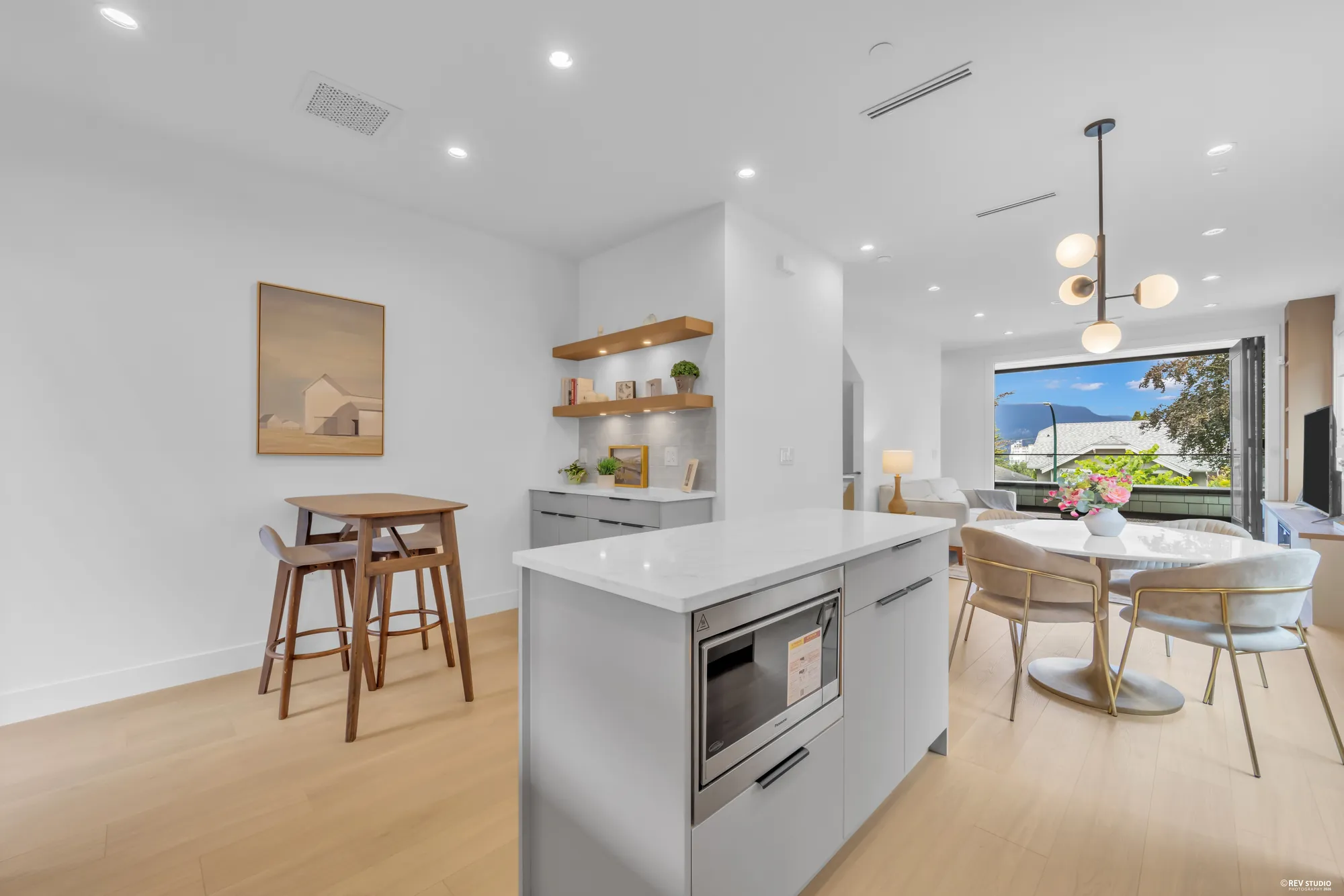 Kitchen island with stools, looking through to the dining area