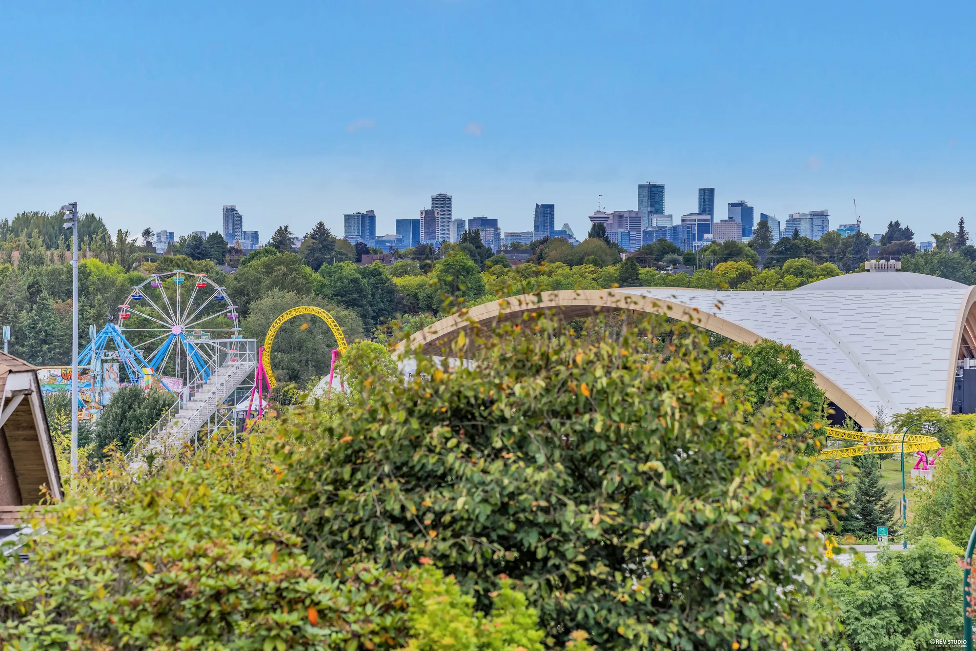 Playland rides in Hastings Park with downtown towers on the horizon